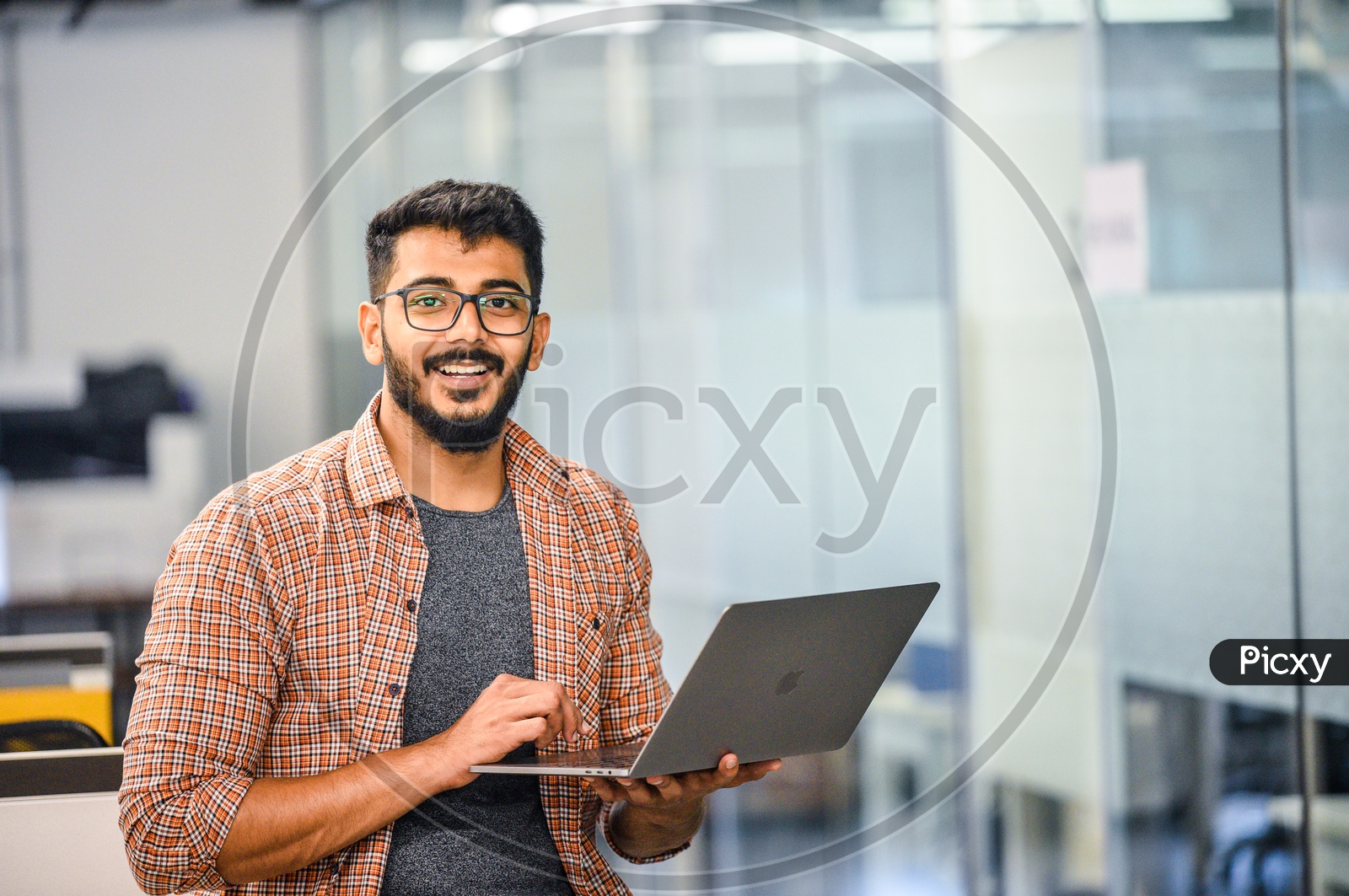 Indian IT  Professional employee   Happily Smiling Using Laptop in Working Space