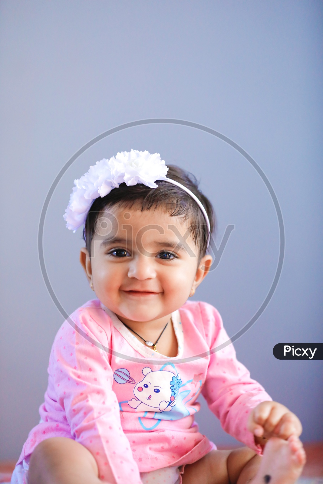Cute Indian Baby Girl With Smiling Face On an Isolated White Background
