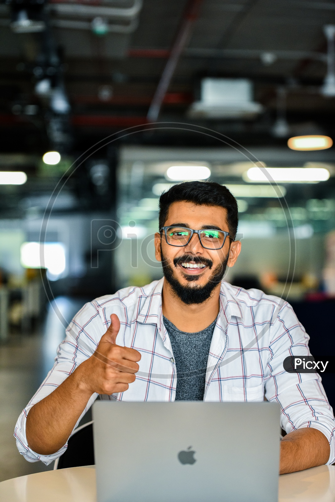 Confident Indian IT Professional Employee Young Man  Student With Thump Up Gesture Happily Smiling With Laptop on Desk