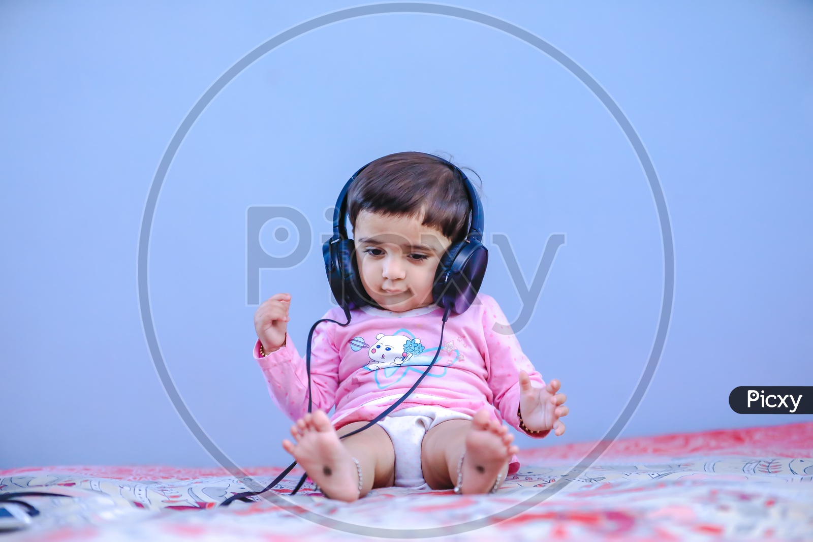 Cute Indian Baby Girl Listening Music  In Headphones
