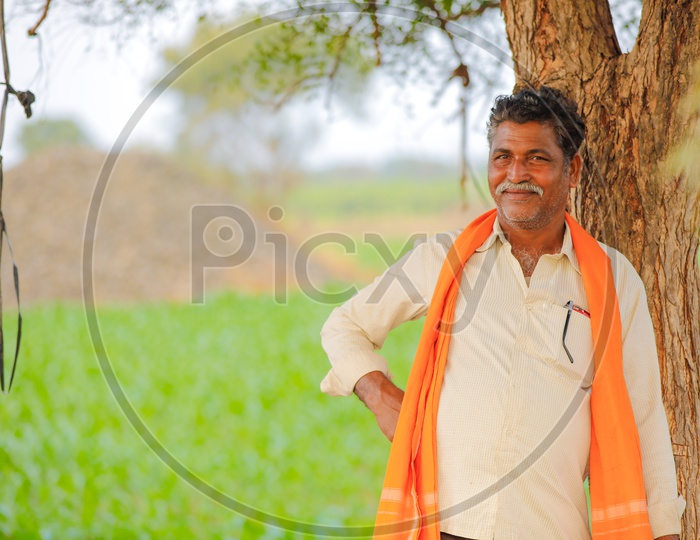 Indian Farmer With Happy Smile  Face In Agricultural Field