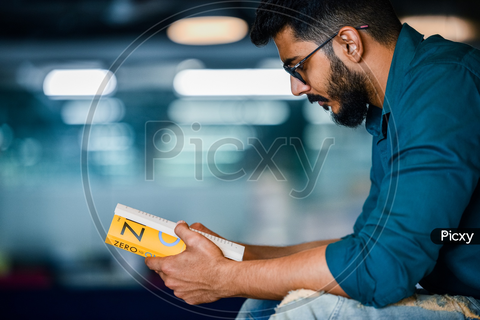 Young Man Or Student With Beard  Reading Book Or Novel