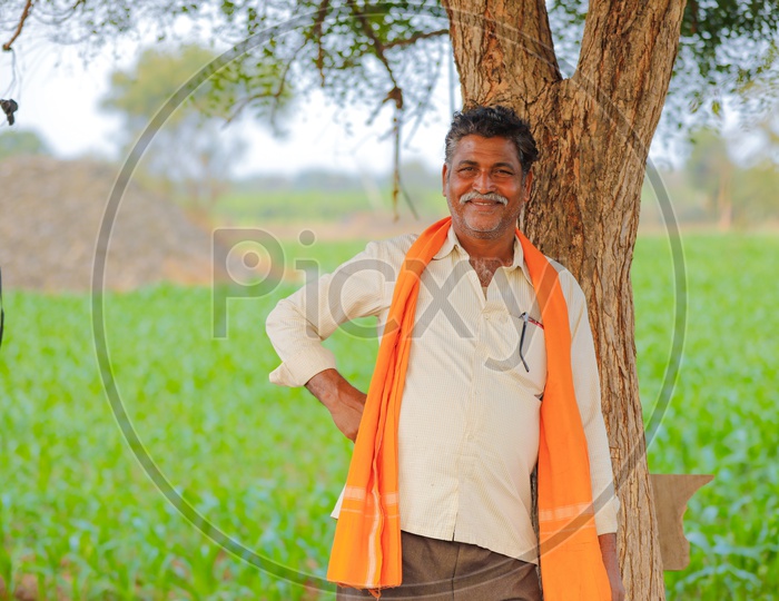 Indian Farmer With Happy Smile  Face In Agricultural Field