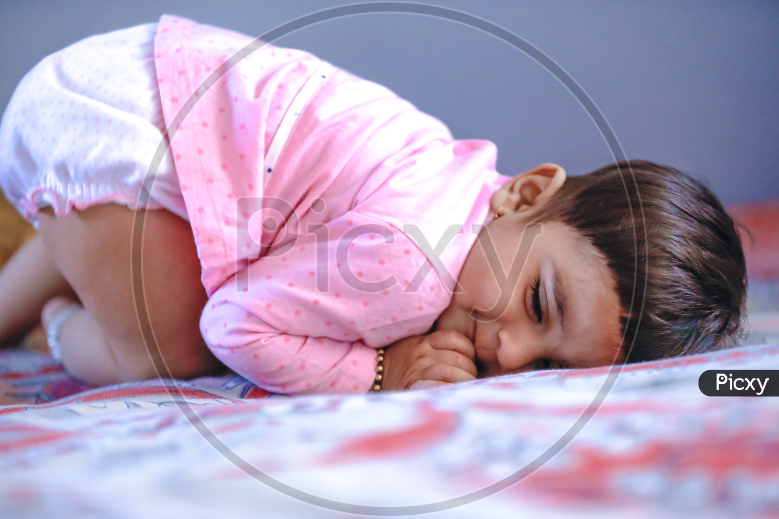 Cute Indian Baby Girl Playing On Bed