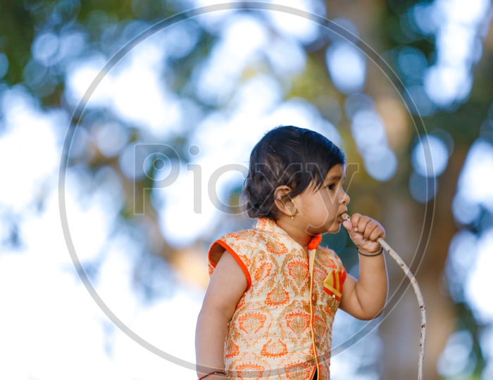 Indian Baby Girl Or Girl Child Playing In Park With A Smiling Face