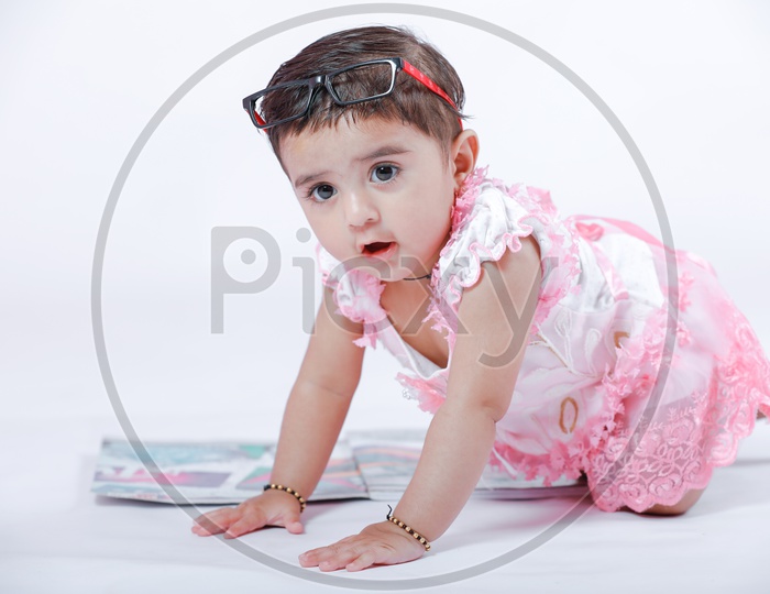 Cute Indian Baby Girl Playing With Books