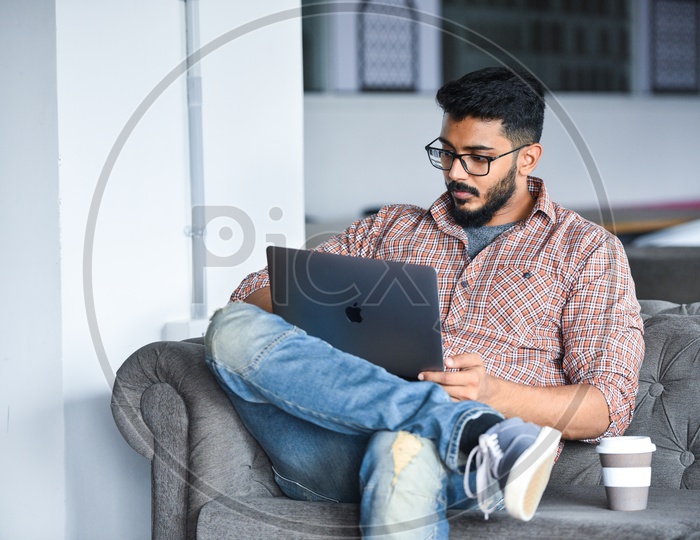 Focused Serious Working Young Man Or Indian Man On Laptop