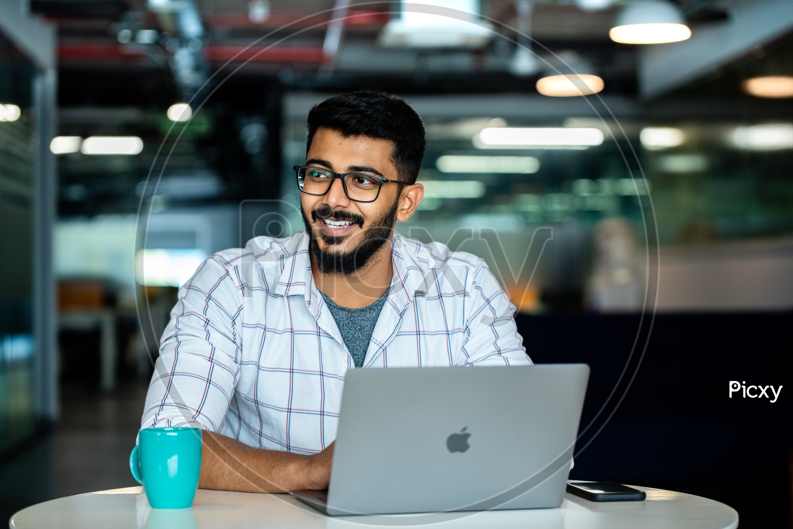 Indian IT Professional Employee Young Man Student  Happily Smiling Using Laptop in Working Space