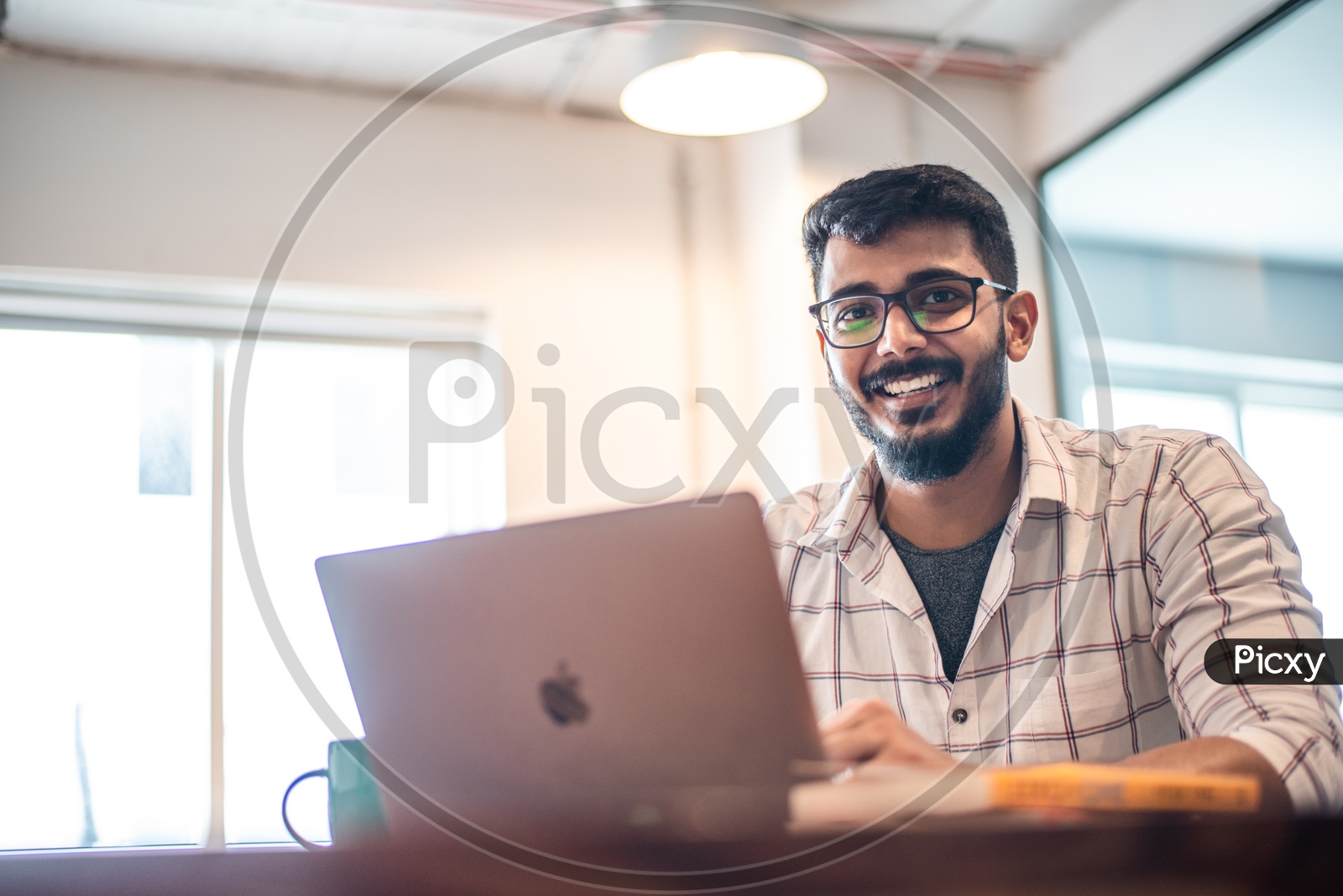 Student Indian  IT  professional Employee Young Man  Happily Smiling Using Laptop in Working Space