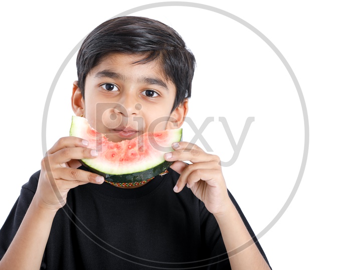 Indian Cute Boy  or  Asian Boy or kid Enjoy Eating  Watermelon With an Expression On an Isolated White Background