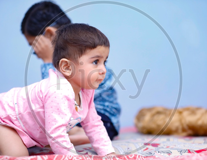 Cute Indian Baby Girl Playing With Siblings or Brother