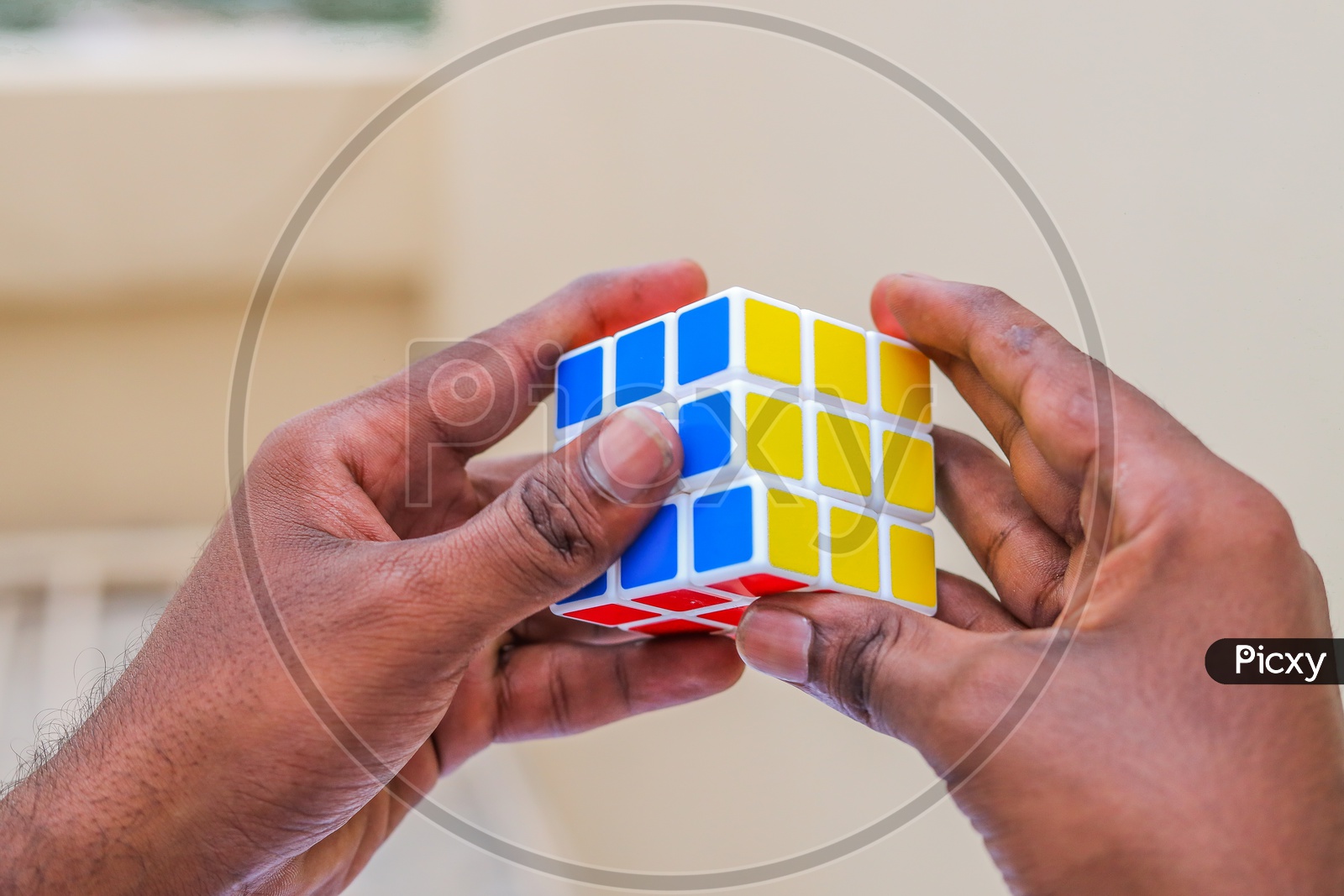 Hands and Rubik's cube puzzle isolated on the white background