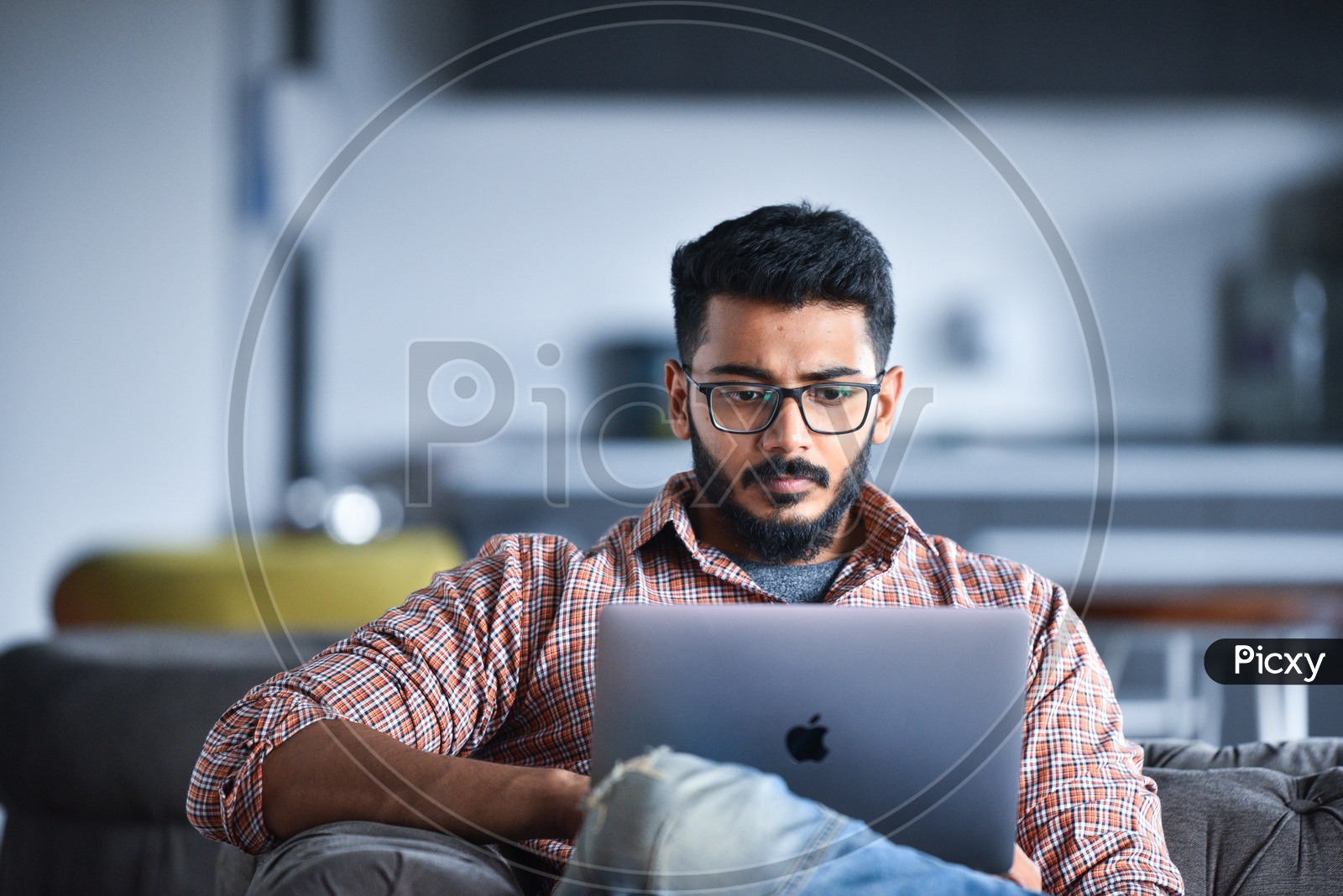Focused Serious Working Young Man Or Indian Man On Laptop At  Work Space