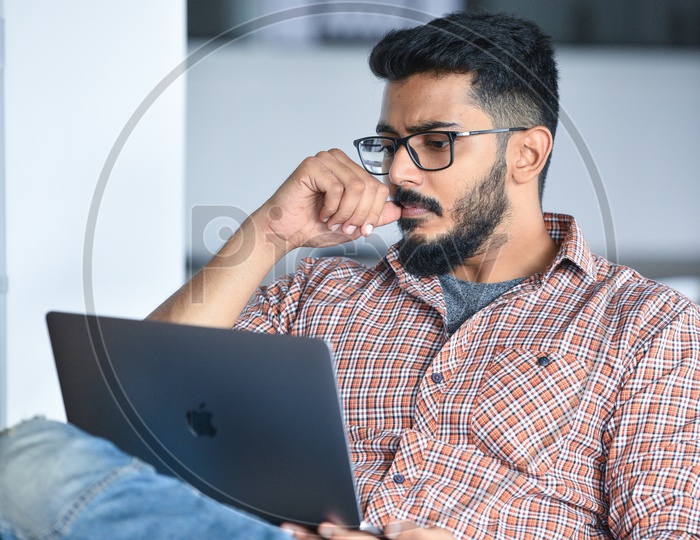 Focused Serious Working  Indian IT Professional  Employee  Young Man  Student On Laptop At  Work Space