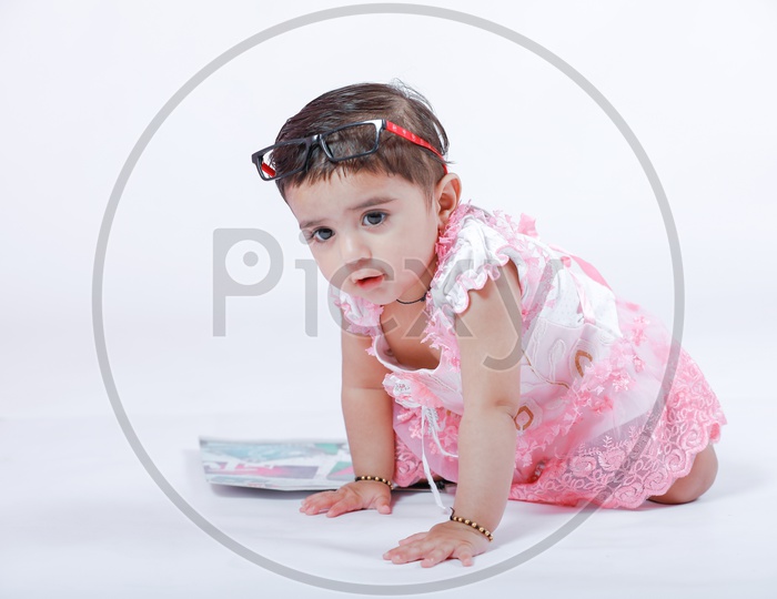 Cute Indian Baby Girl Playing With Books