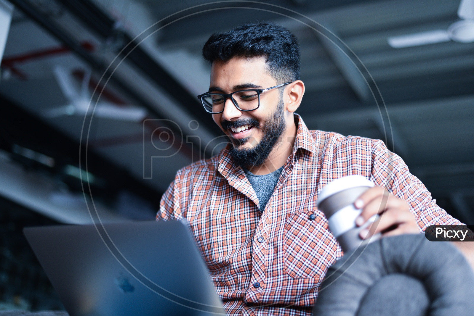 Indian Professional Employee Young Man Student  Happily Smiling Using Laptop in Working Space