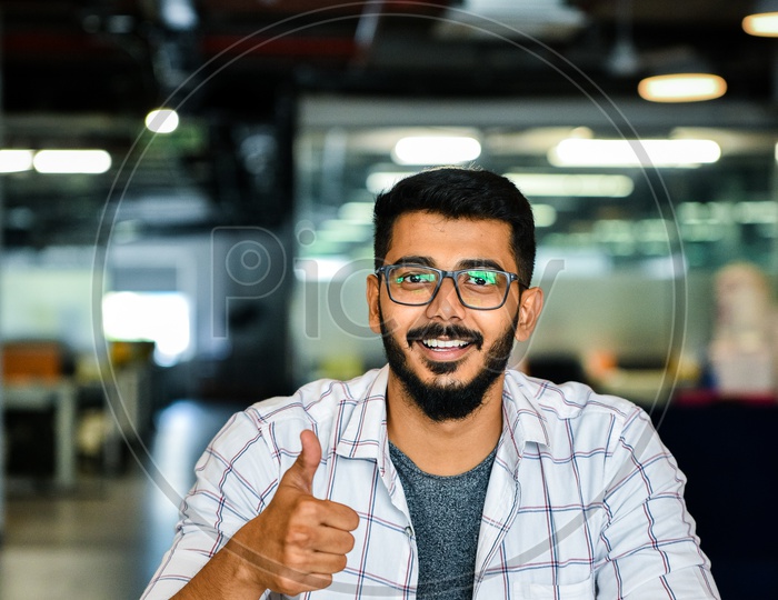Confident Young Man or Indian Man Or Student With Thump Up Gesture Happily Smiling With Laptop on Desk