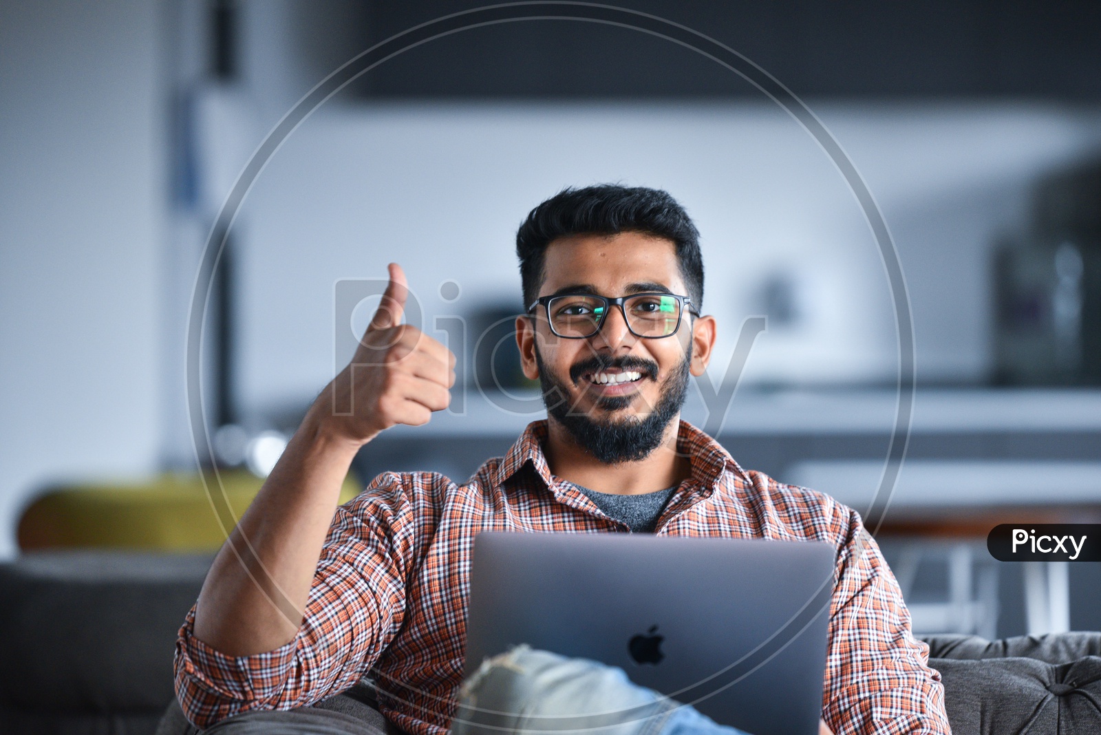 Confident smiling  Indian Professioanl Employee Young Man Student  Showing Thumb up Gesture While Working  on Laptop