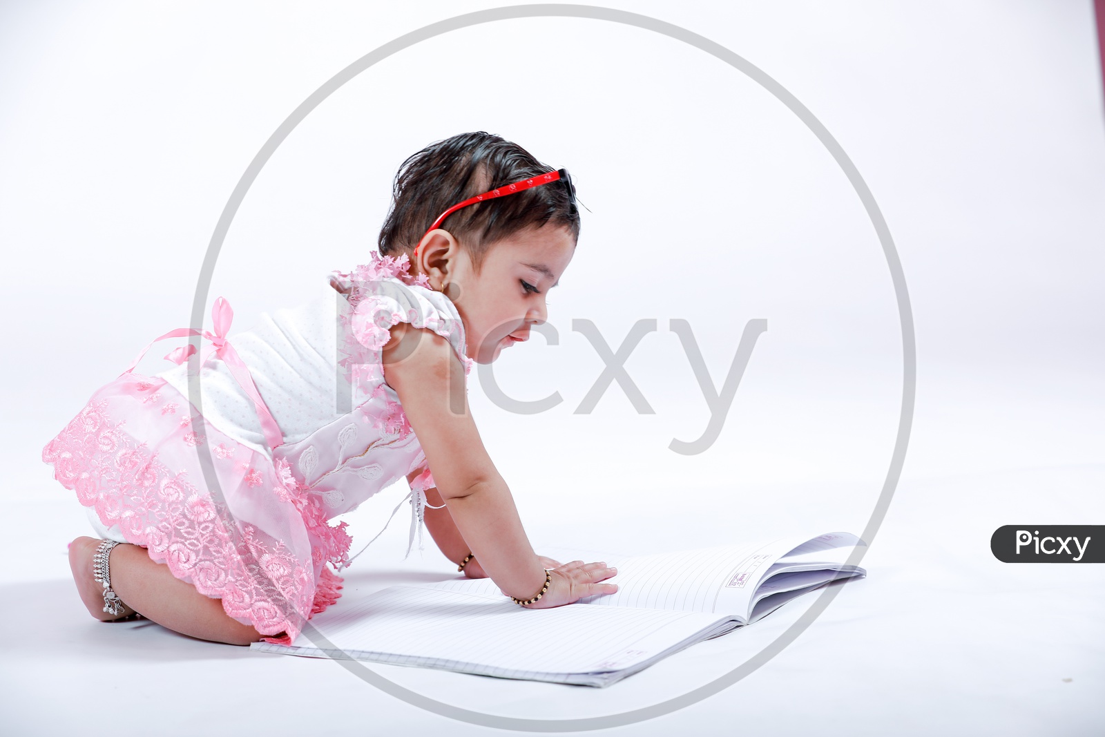 Cute Indian Baby Girl With Book