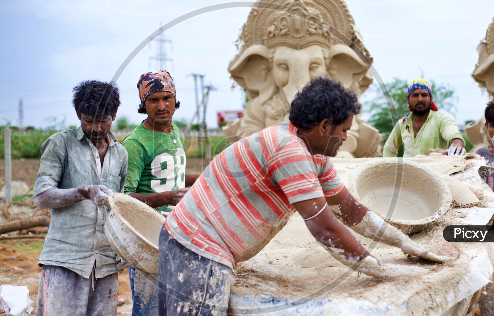 Workers making Ganesh statues with plaster of paris.
