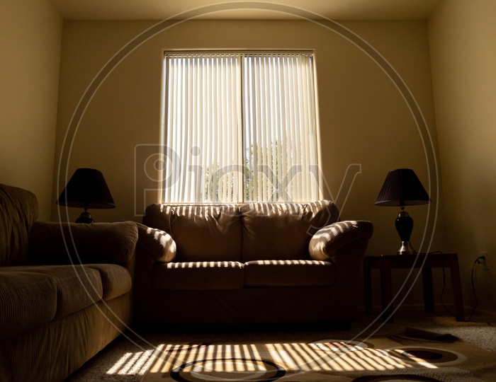 Sun rays emerging into living room on a beige couch.