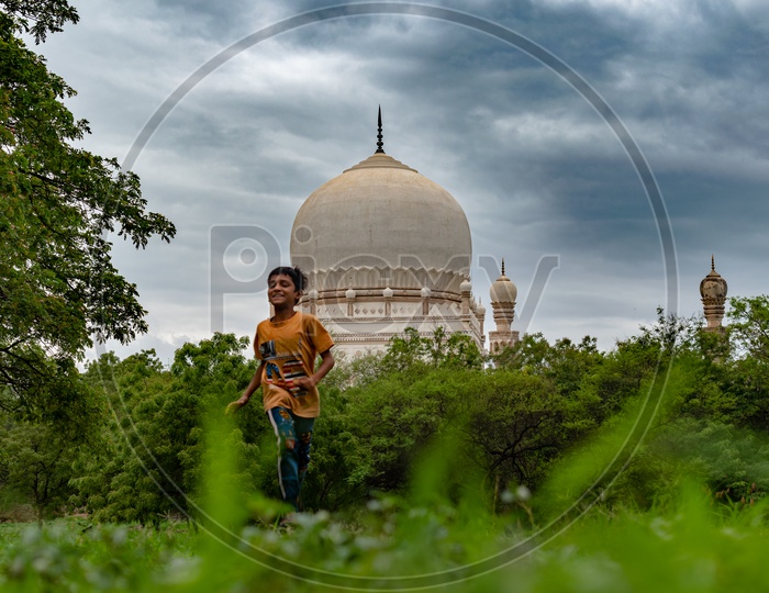 Kid running infront of Tomb of Hayat Bakshi Begum,Qutb Shahi Tombs, Qutub Shahi Tombs, Hyderabad.