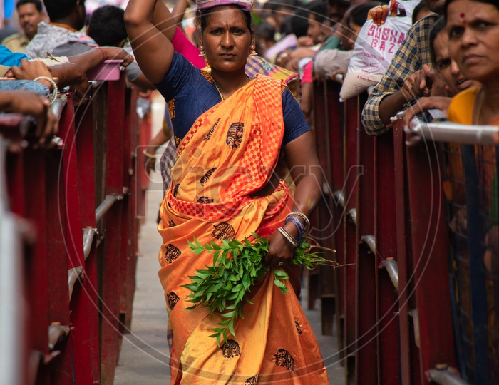 Women dressed up in traditional wear carrying bonalu to Ujjaini Mahankali Temple, Secunderabad on the eve of Bonalu festival .