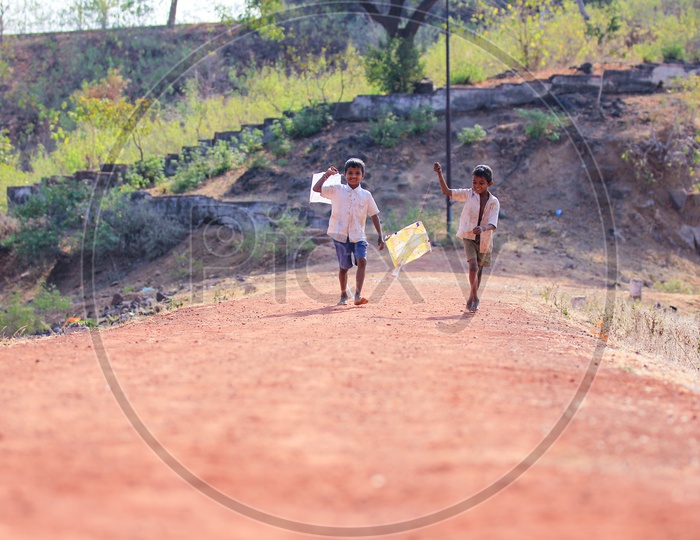 Indian Rural Village Kids or Children Playing With Kite