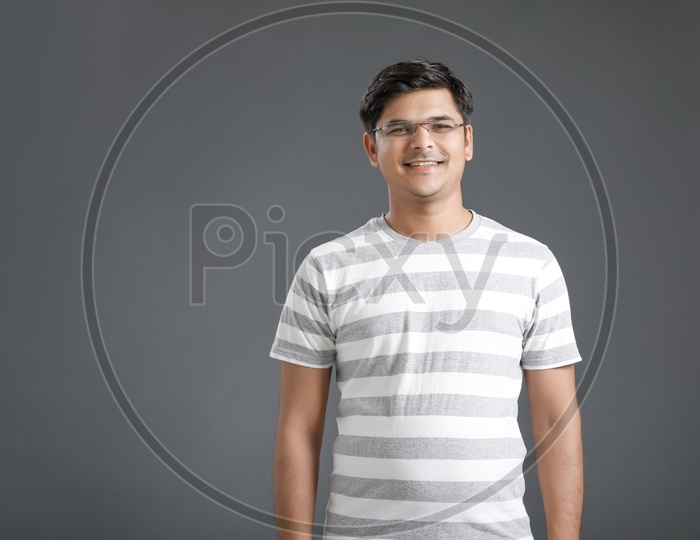 Young Man or Indian Man With Smile Face And Posing On an Isolated Black Background