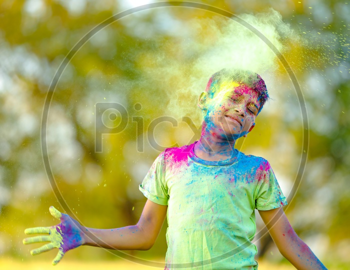 Indian Boy or Young Boy Playing With Holi Colours  With Different Expressions on His Face
