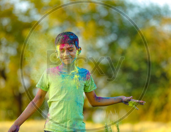 Indian Boy or Young Boy Playing With Holi Colours  With Different Expressions on His Face