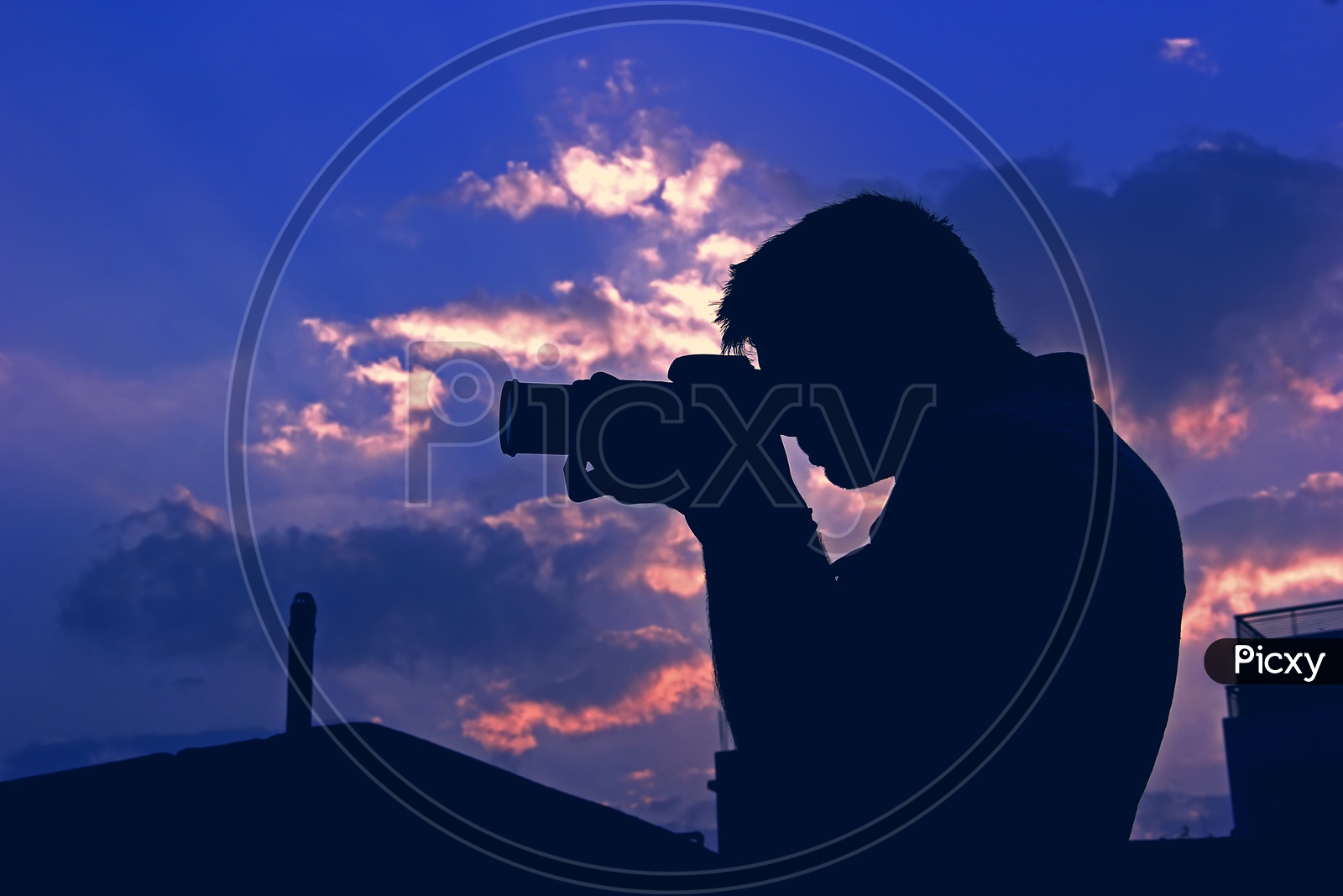 Silhouette Of a Photographer Over Blue Hour Sky In Background