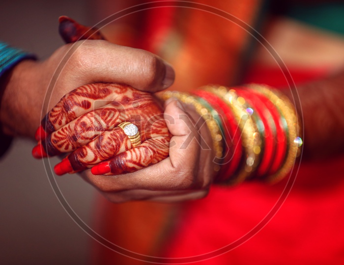 Couple Holding Hands Wearing Traditional Wear on an Marriage Engagement Ceremony
