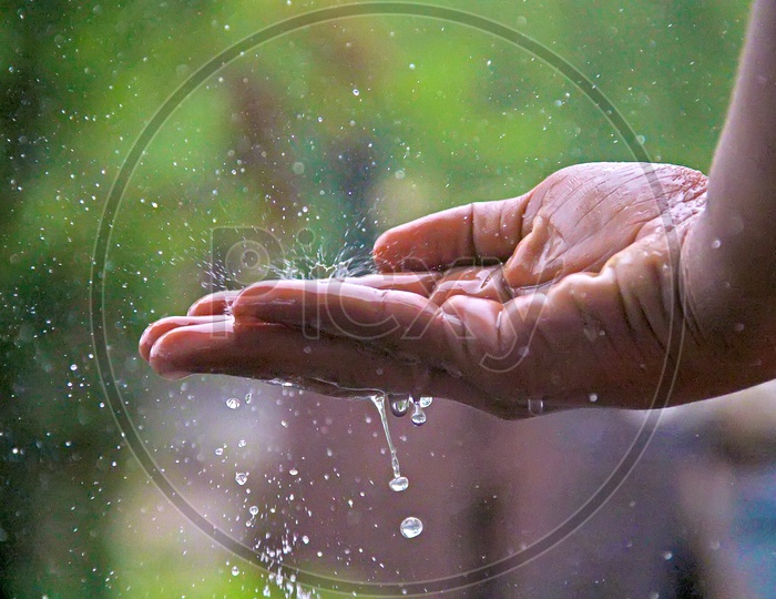 Water Droplets  Falling In Hand Closeup