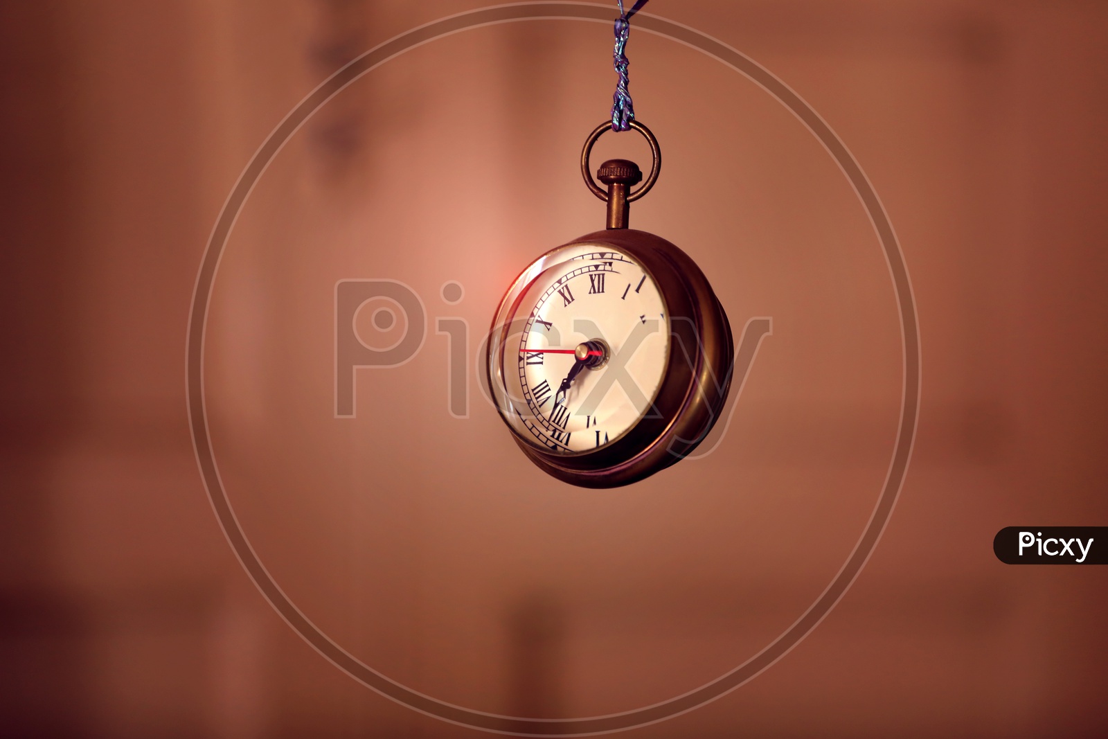 Pocket Watch Hanging Over a Isolated Background