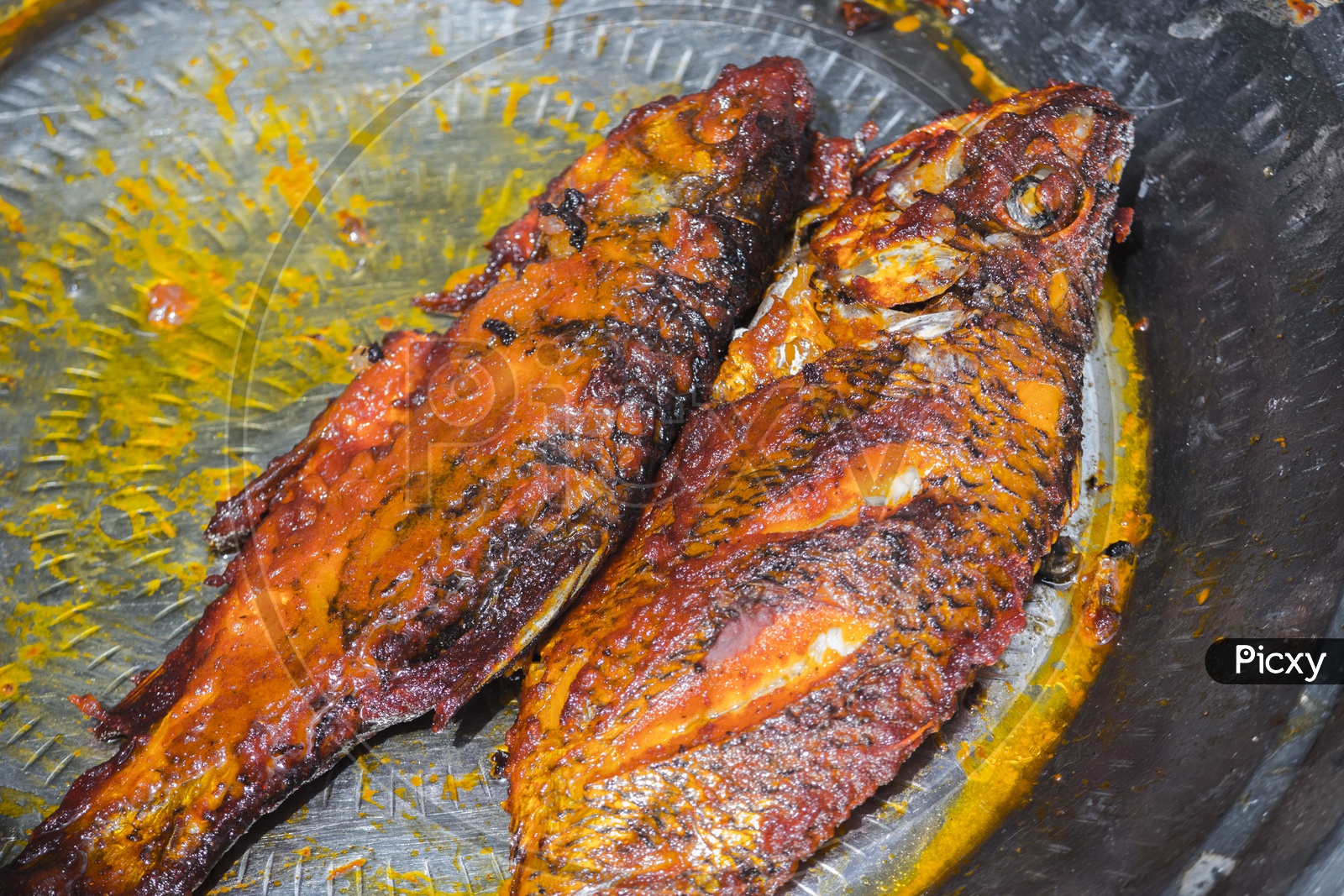The cooking process of Fish fry in Hogenekkal.