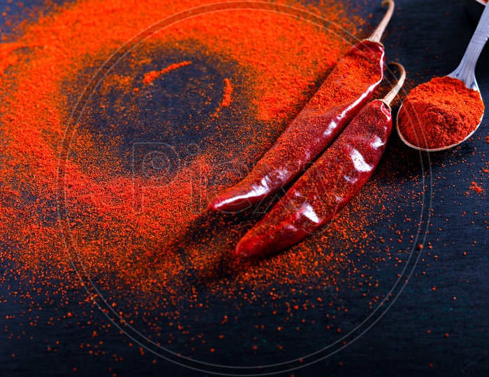 Red Chilli  Or Pepper Powder  With Flakes On an Isolated Black Background