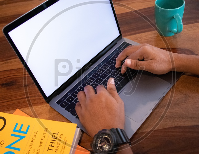 Young Man Or Student Hands On Laptop Keyboard  On Wooden Desk Background