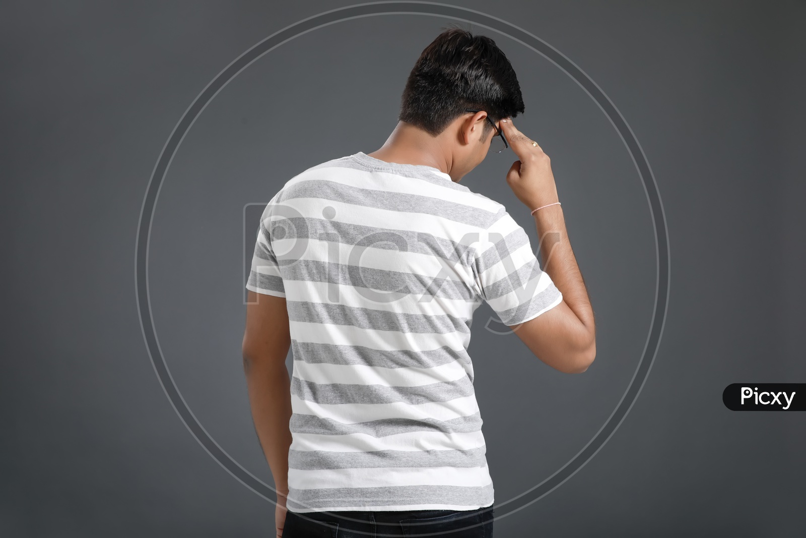 Frustrated Stressed Young Man Holding Head With Hands And Posing Over an Isolated Black Background