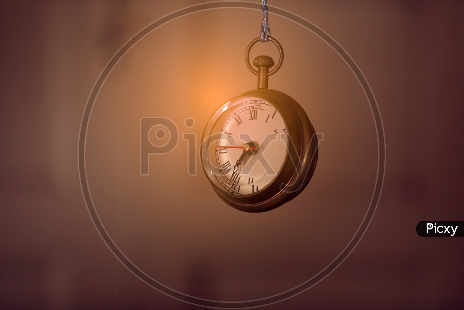 Pocket Watch Hanging Over a Isolated Background