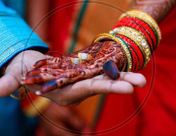 Couple Holding Engagement Rings on Hand  Wearing Traditional Wear on an Marriage Engagement Ceremony