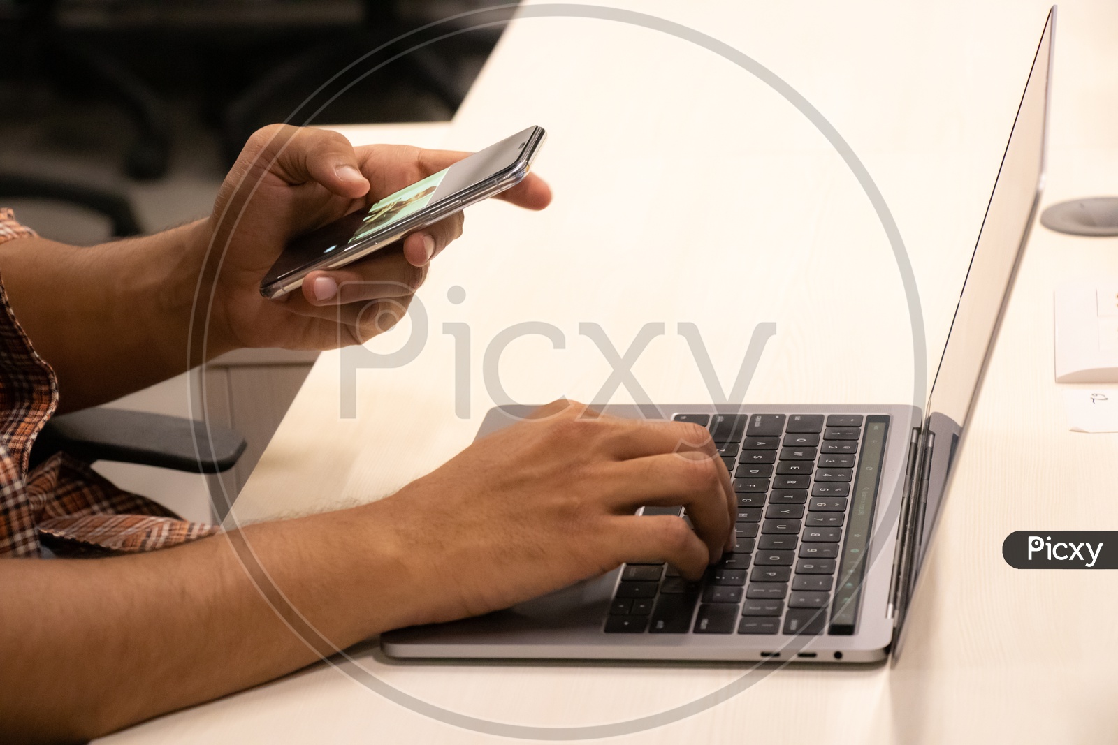 Young man Or Student Hands Using Mobile Or Smartphone While Working On Laptop  Closeup