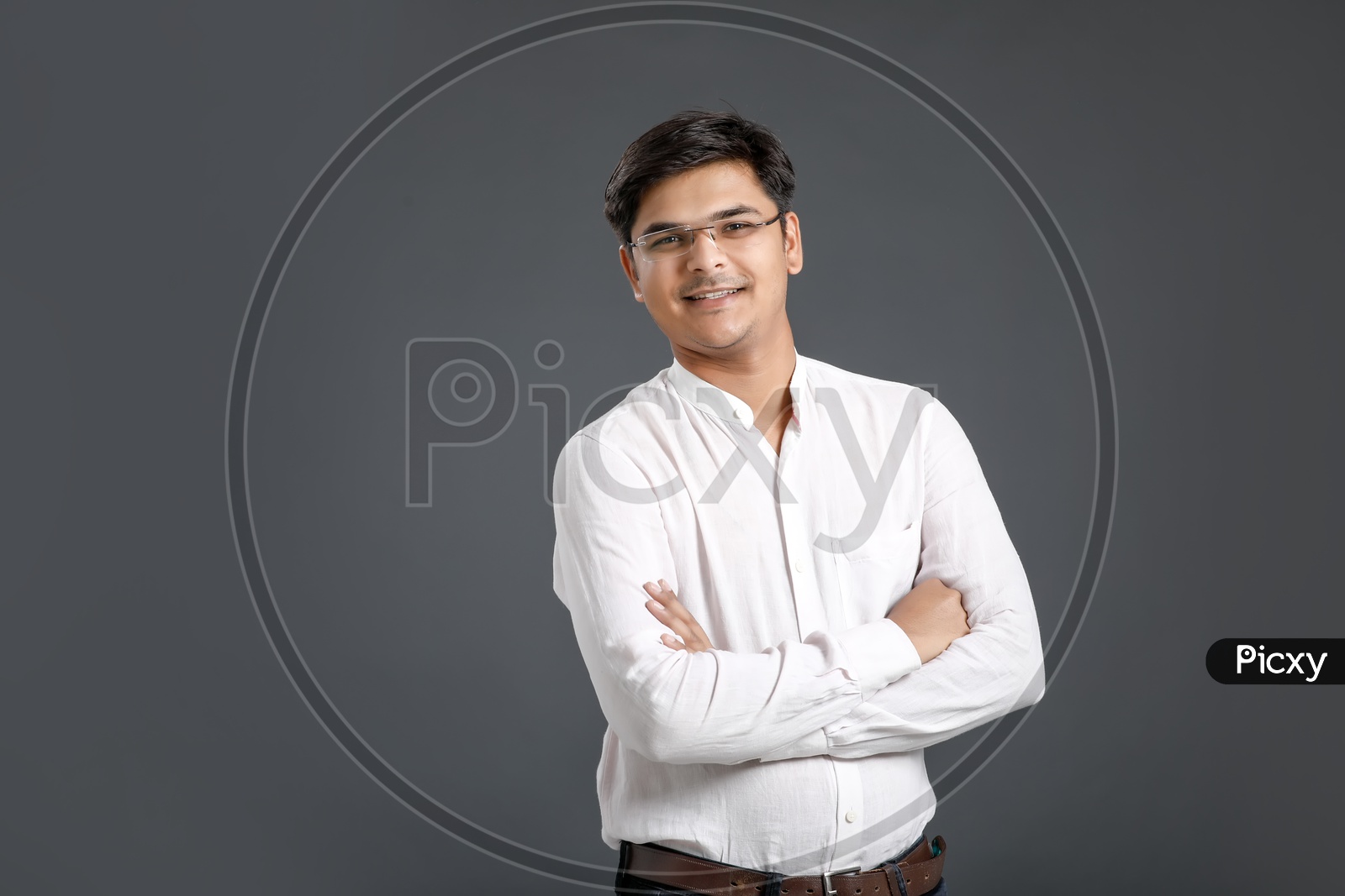 Young Man or Indian Man Happily Smiling  and Posing Over an Isolated Black Background