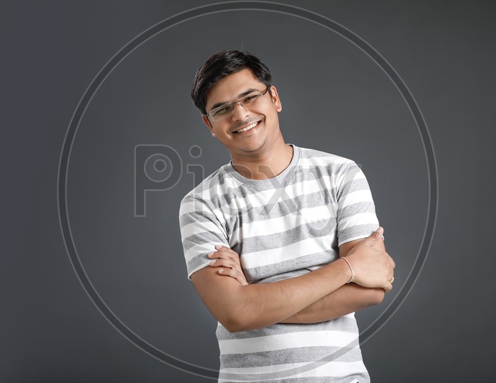 Young Man or Indian Man Happily Smiling  and Posing Over an Isolated Black Background