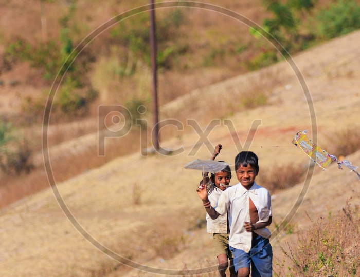 Indian Rural Village Kids or Children Playing With Kite
