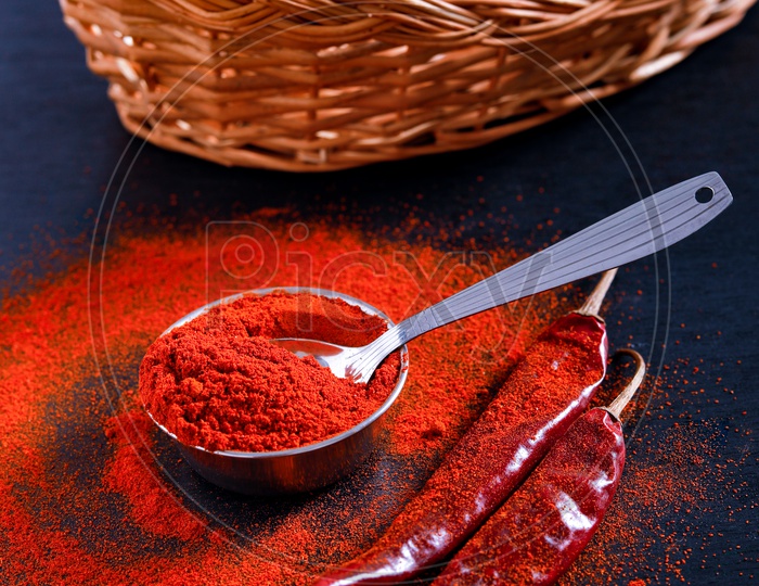 Red Chilli  Or Pepper Powder  With Flakes On an Isolated Black Background