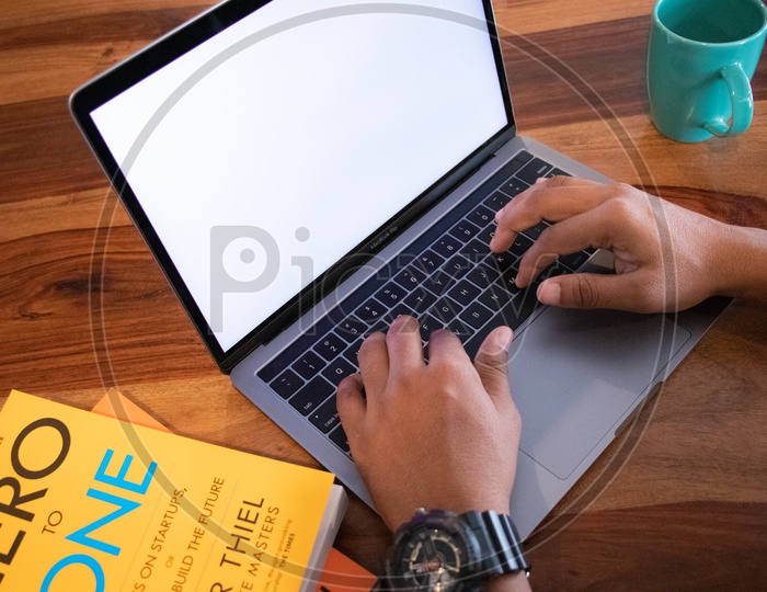 Young Man Or Student Hands On Laptop Keyboard  On Wooden Desk Background