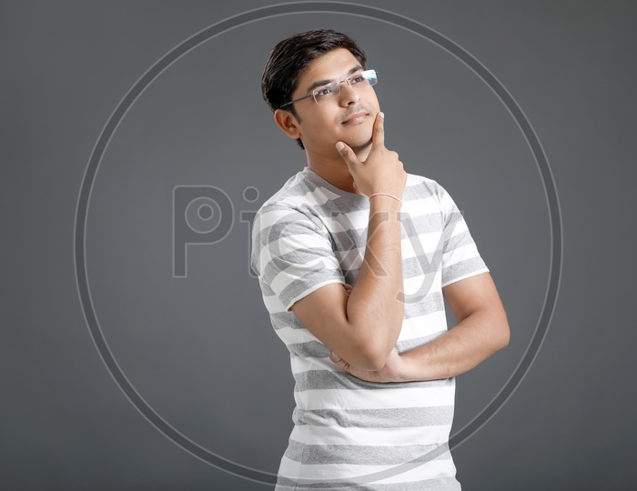 Thinking Young Man or Indian Man  Posing On an Isolated Black Background
