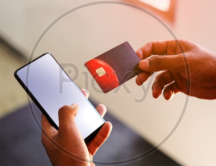 Online Payments Online Shopping   A Man Using Debit or Credit Card For Online Transactions In Smartphone or Mobile