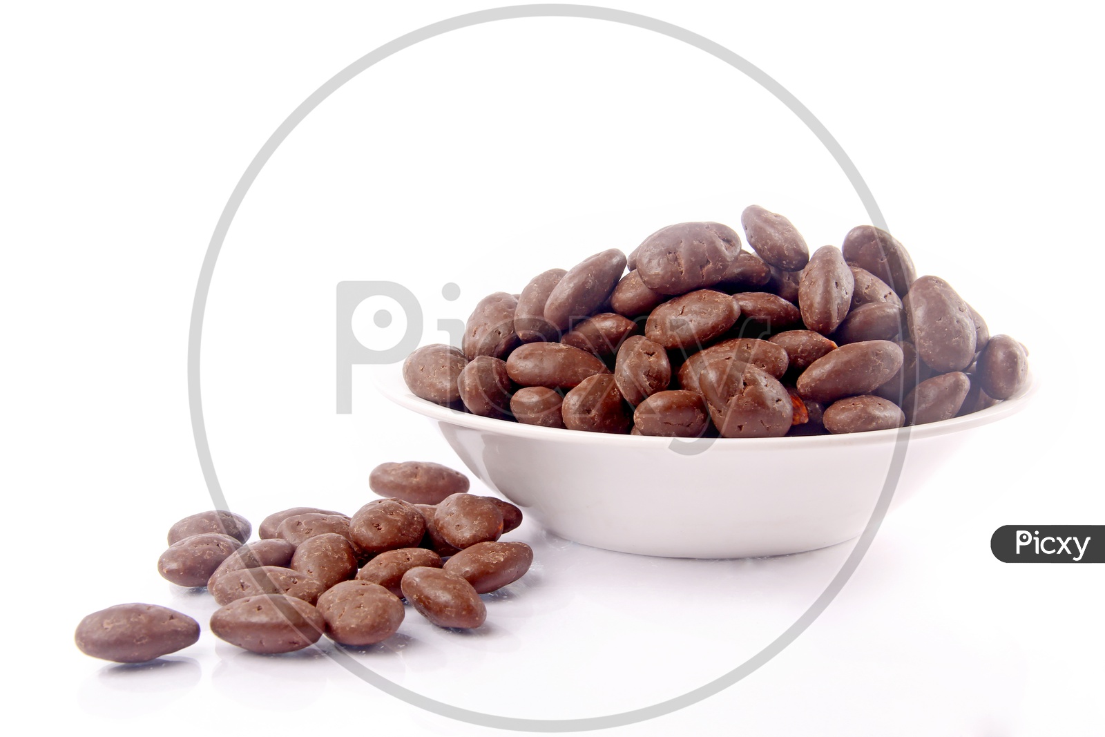 Chocolate Coated Almond Or Badam  in a Bowl On an Isolated White Background